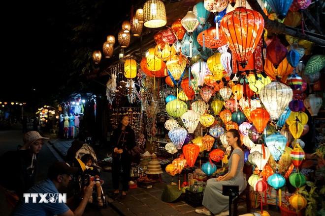 A foreign visitor poses for a photo in Hoi An Ancient Town, Da Nang city. (Photo: VNA)